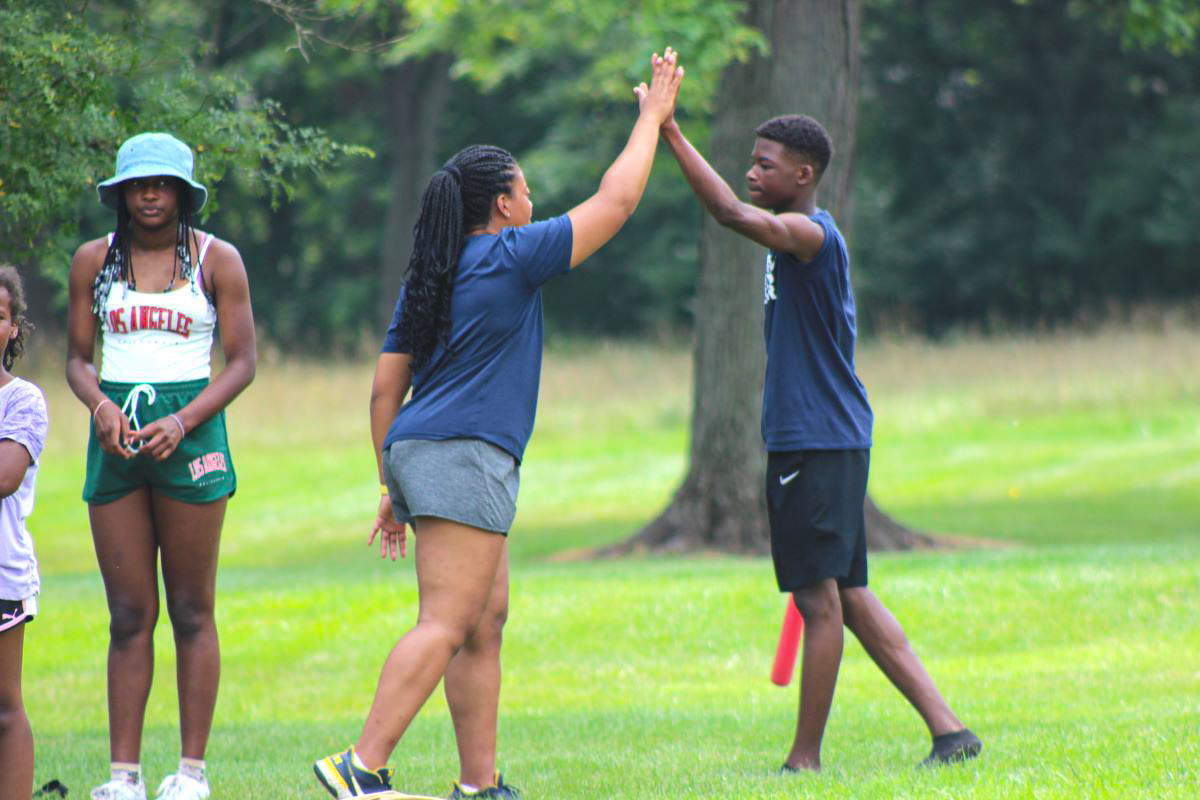 High fives at a Hail! Impact community camp