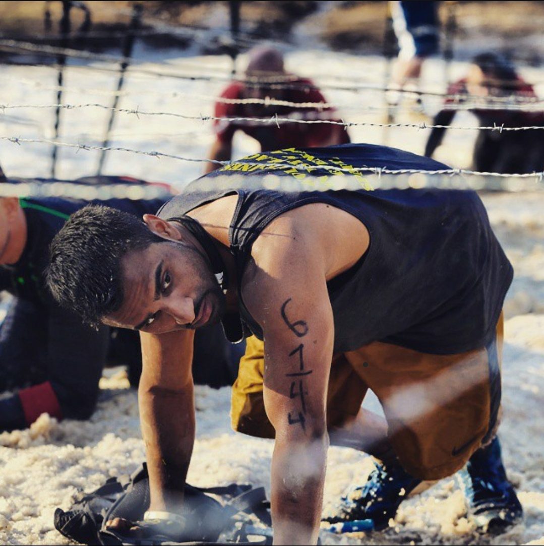 Crawling under barbed wire at a Spartan Race