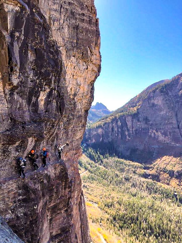 Climbers on a via ferrata ledge near Telluride