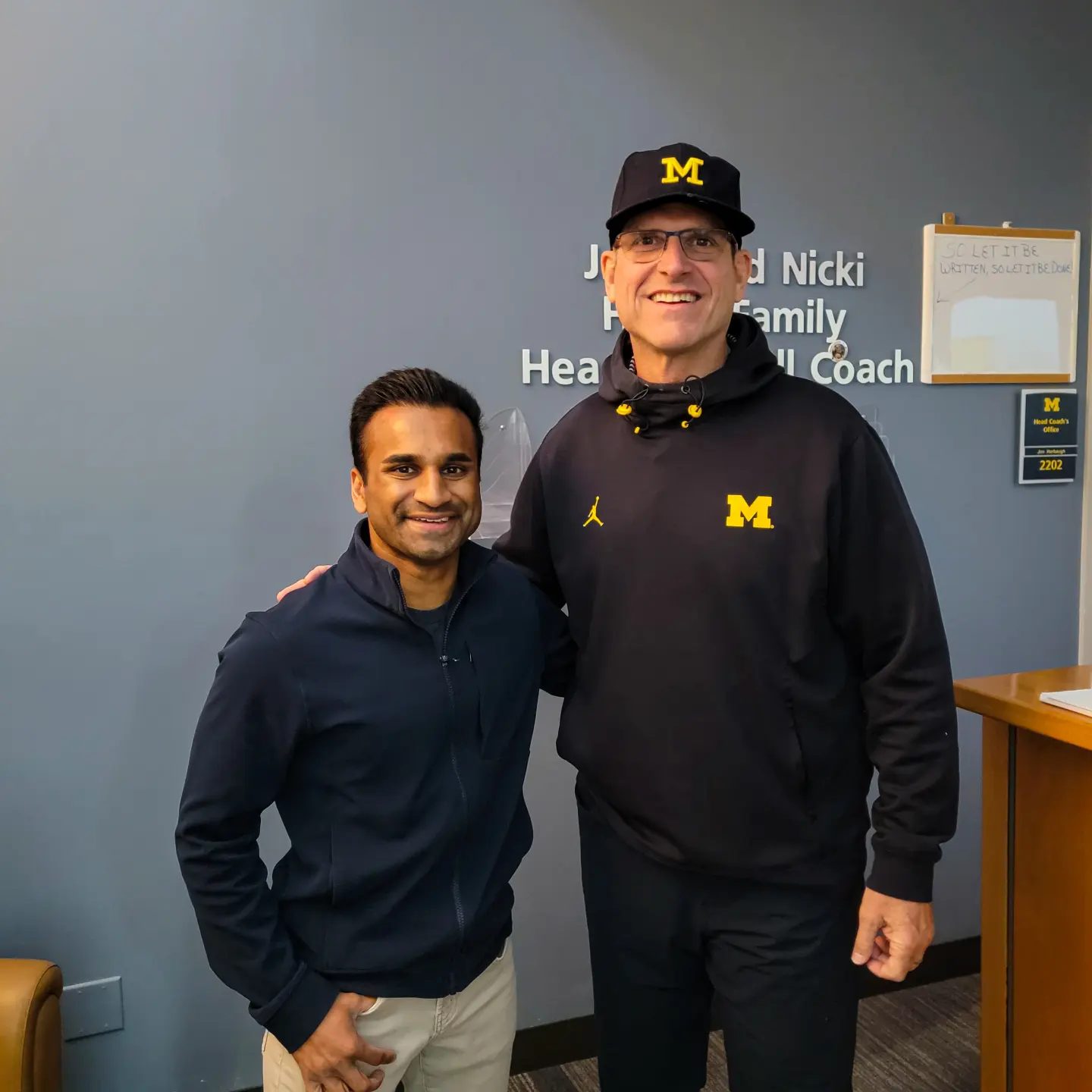 Chin Weerappuli with Coach Jim Harbaugh outside the head coach's office